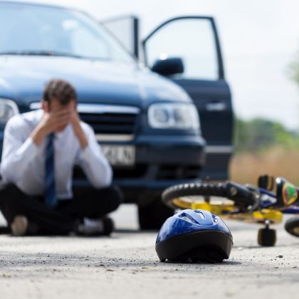 Driver sitting on the street after car accident