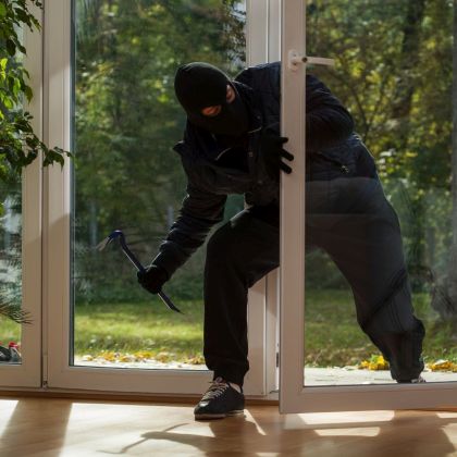 Burglar entering to house trough balcony window