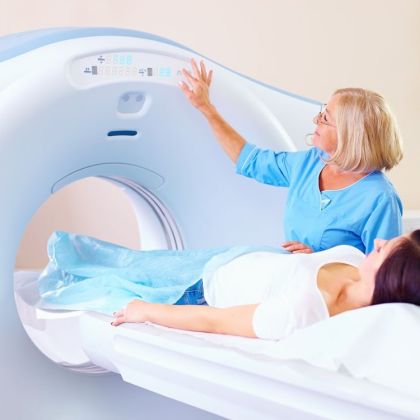mid adult medical staff preparing patient to tomography